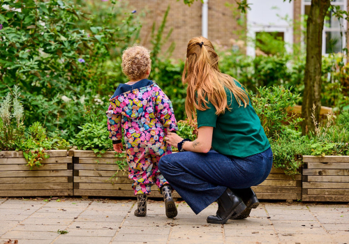 Pedagogisch medewerker met kindje buiten