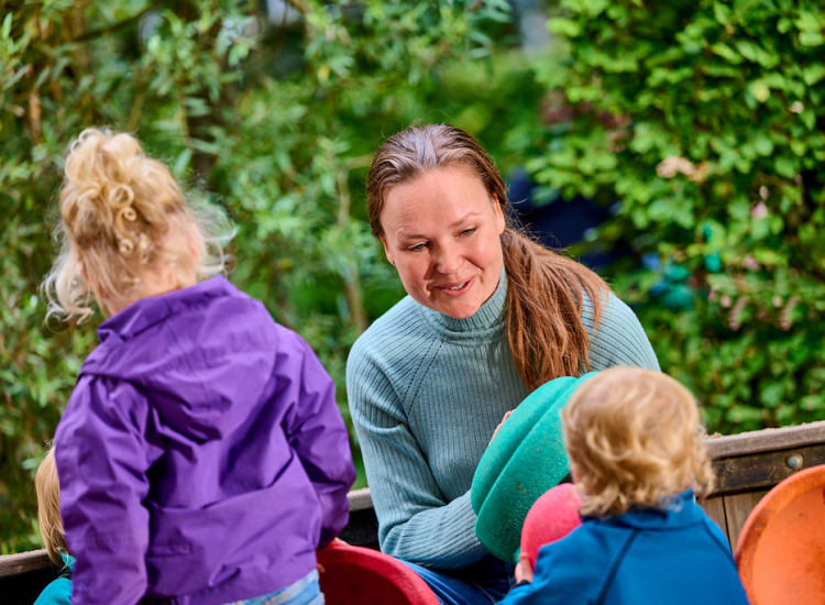Pedagogisch medewerker buiten met kinderen
